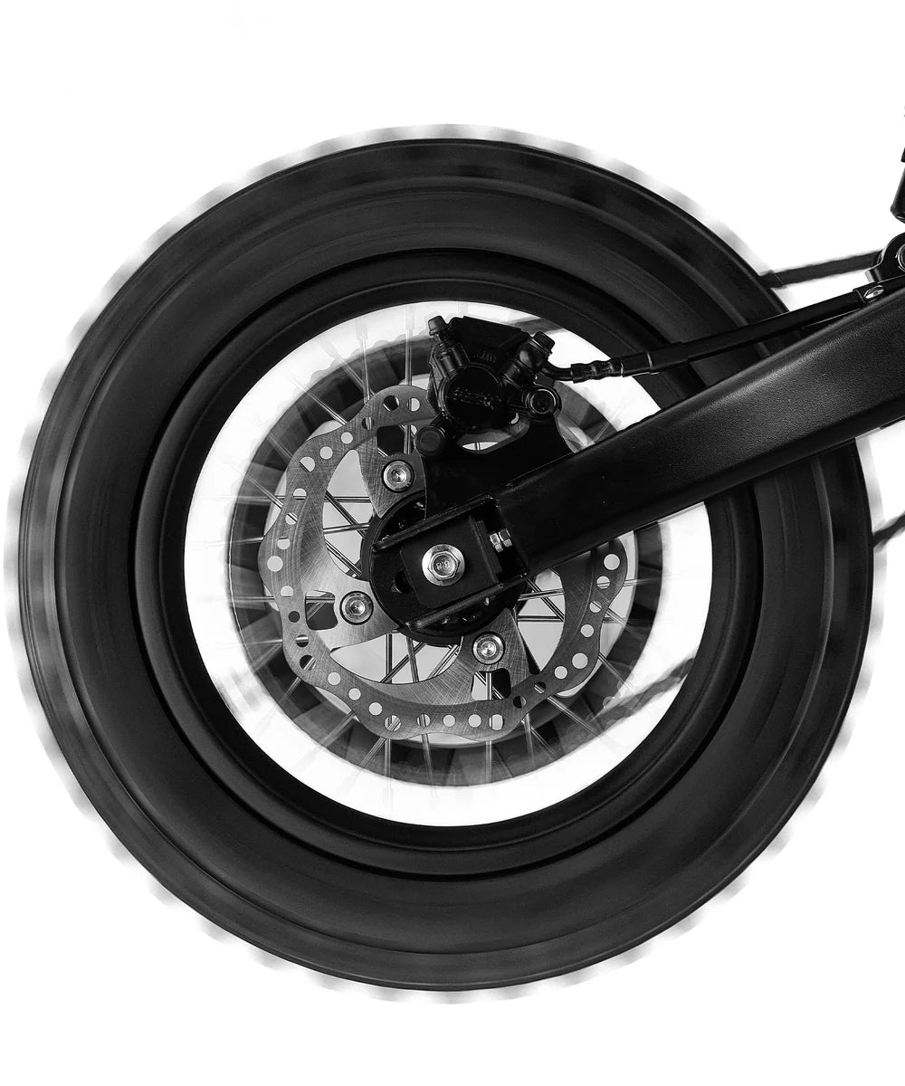 Close-up of a motorcycle wheel with disc brake on a white background